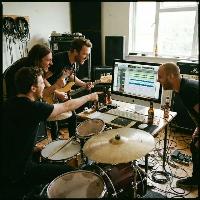 Band members looking at a shared screen during rehearsal